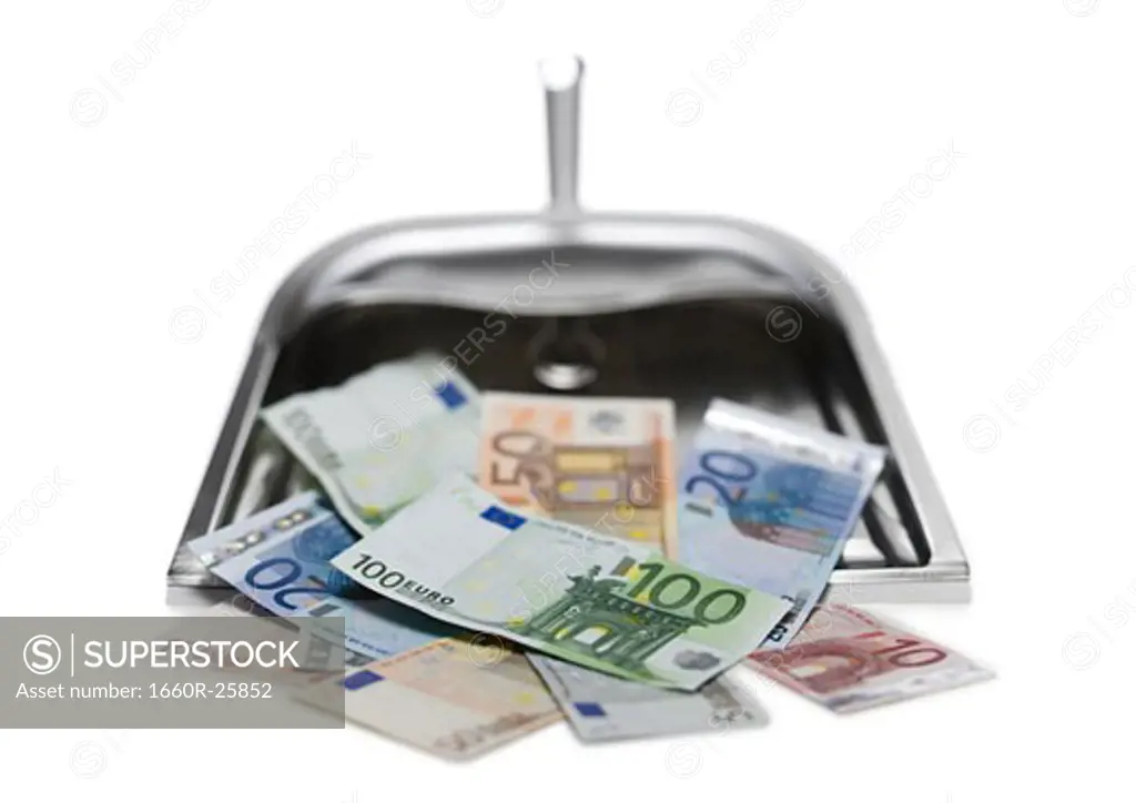 Close-up of Euro notes in a dustpan