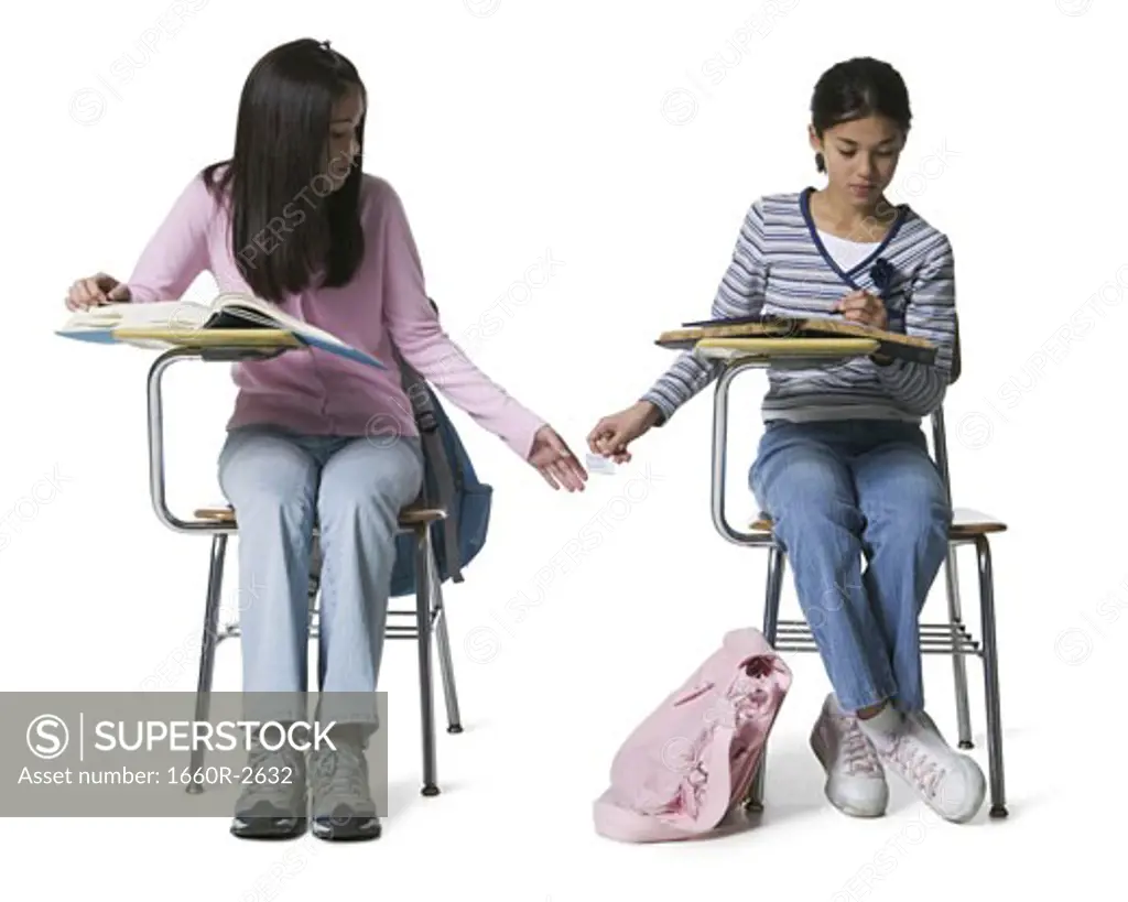 Two girls copying in an examination