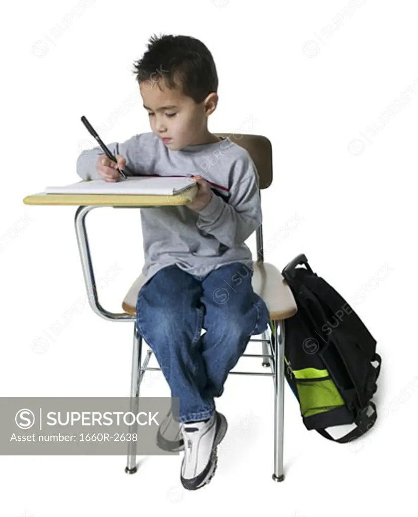 Boy writing on a note pad