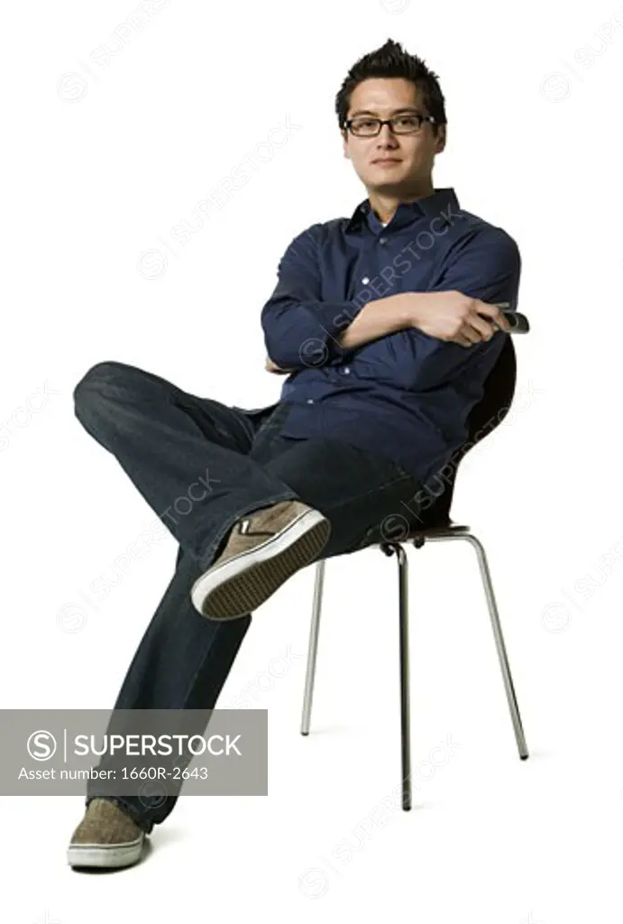 Portrait of a young man sitting on a chair