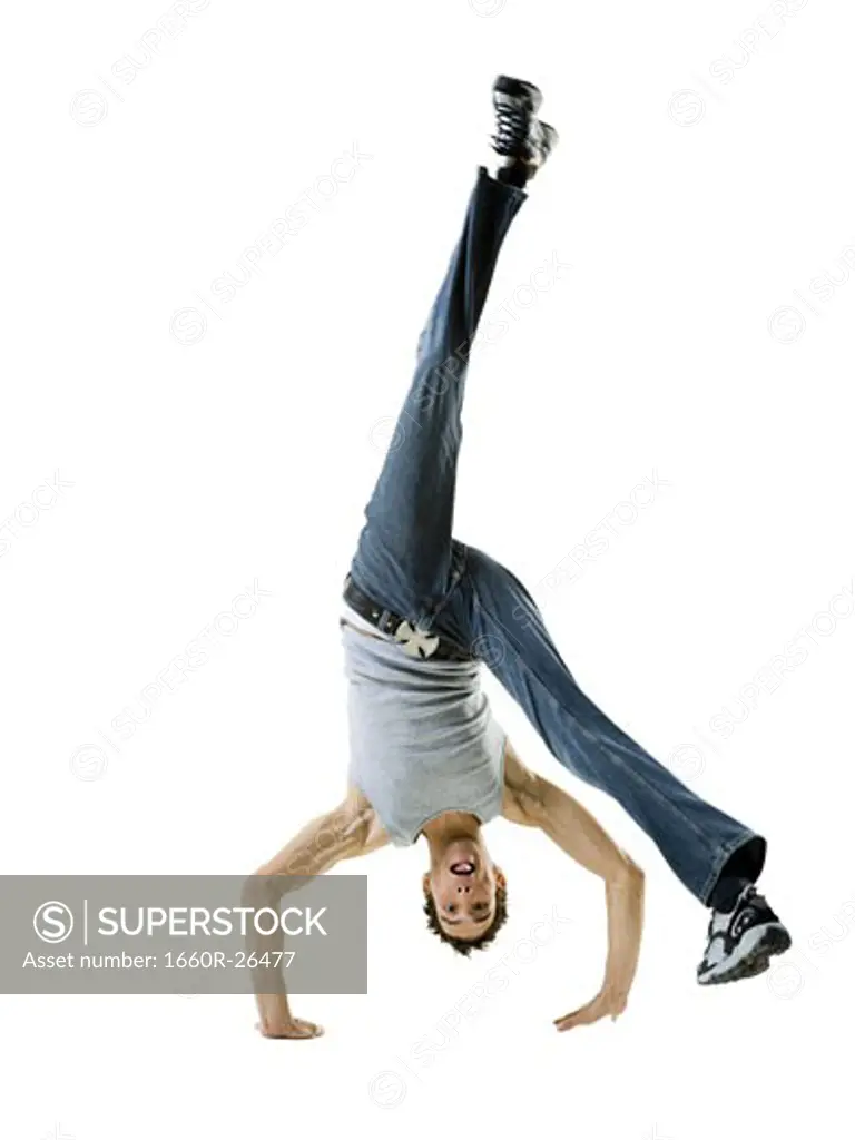 Portrait of a young man doing a back flip