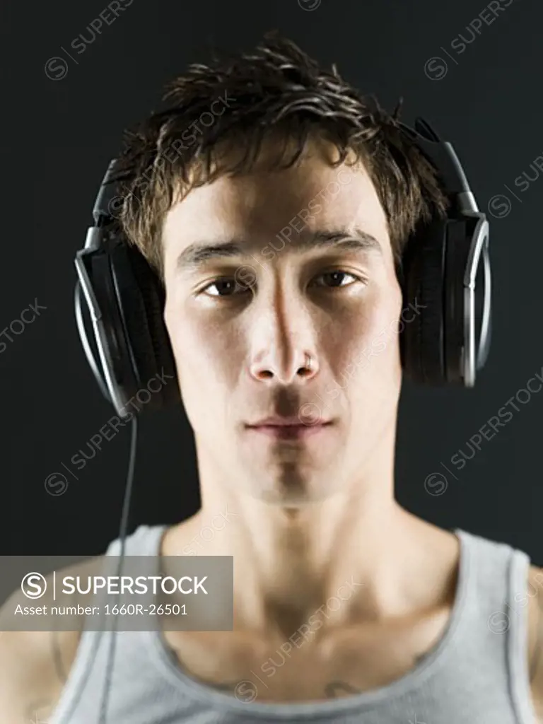 Close-up of a young man with headphones on