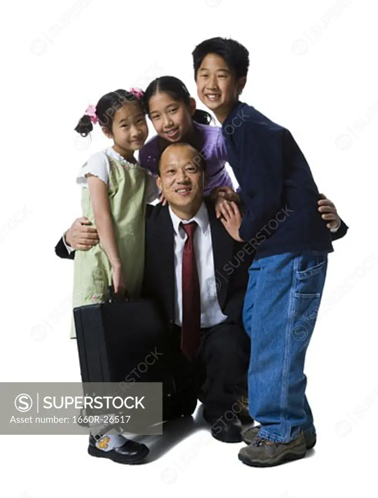 Portrait of a father smiling with his two daughters and son
