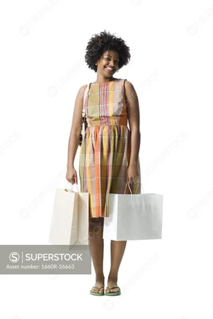 Portrait of a young woman holding shopping bags
