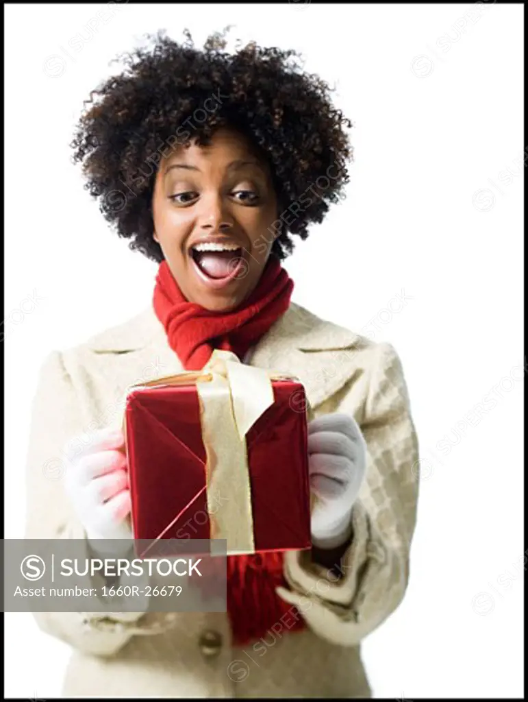 Portrait of a young woman holding a gift box