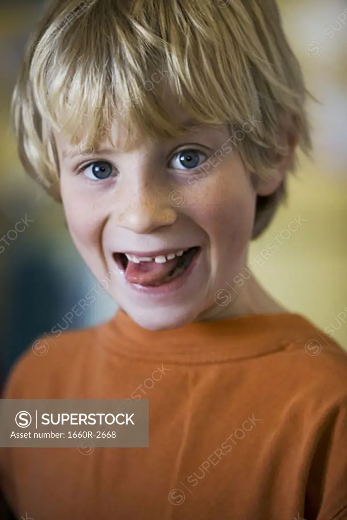 Portrait of a boy sticking out his tongue