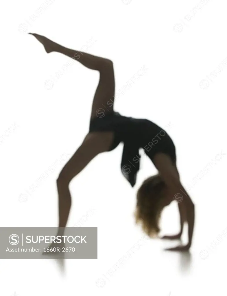 Side profile of a young woman bending over backwards