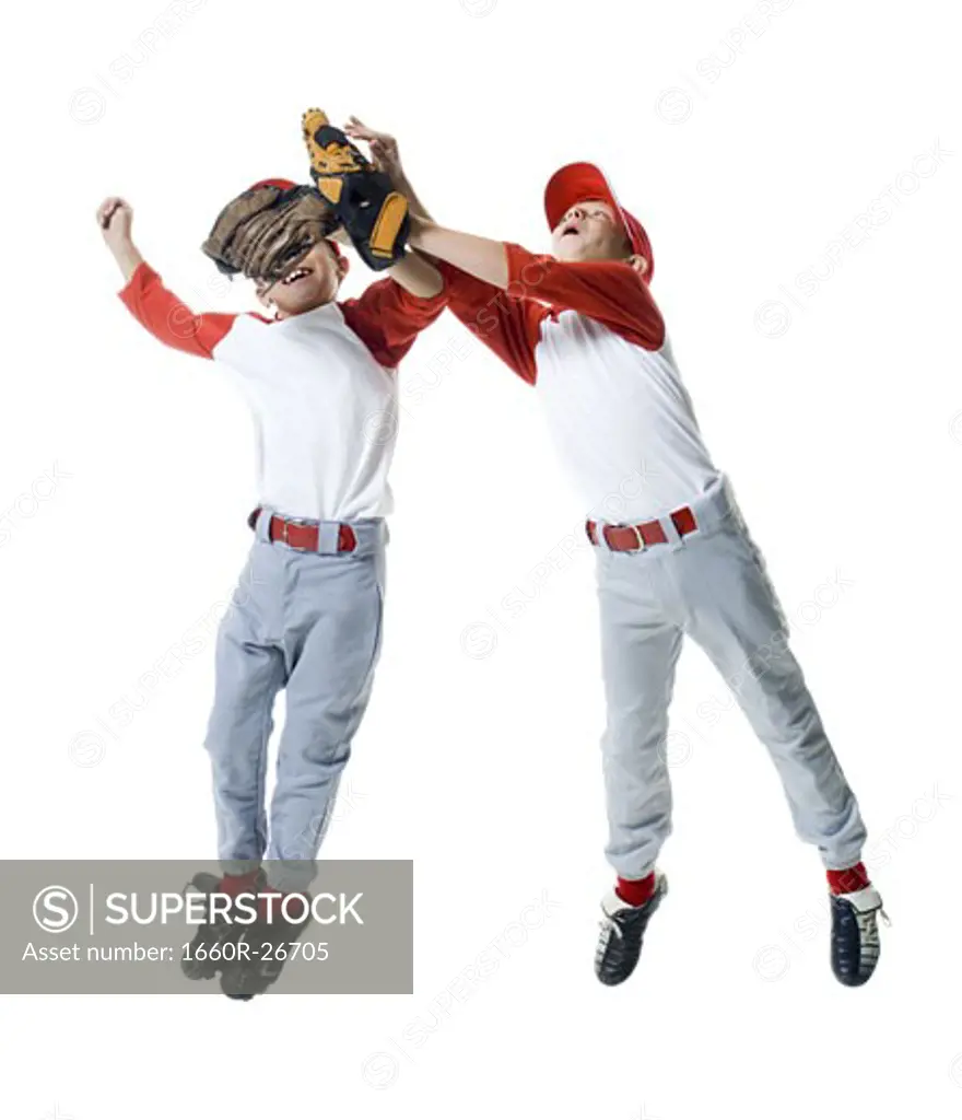 Two baseball players jumping