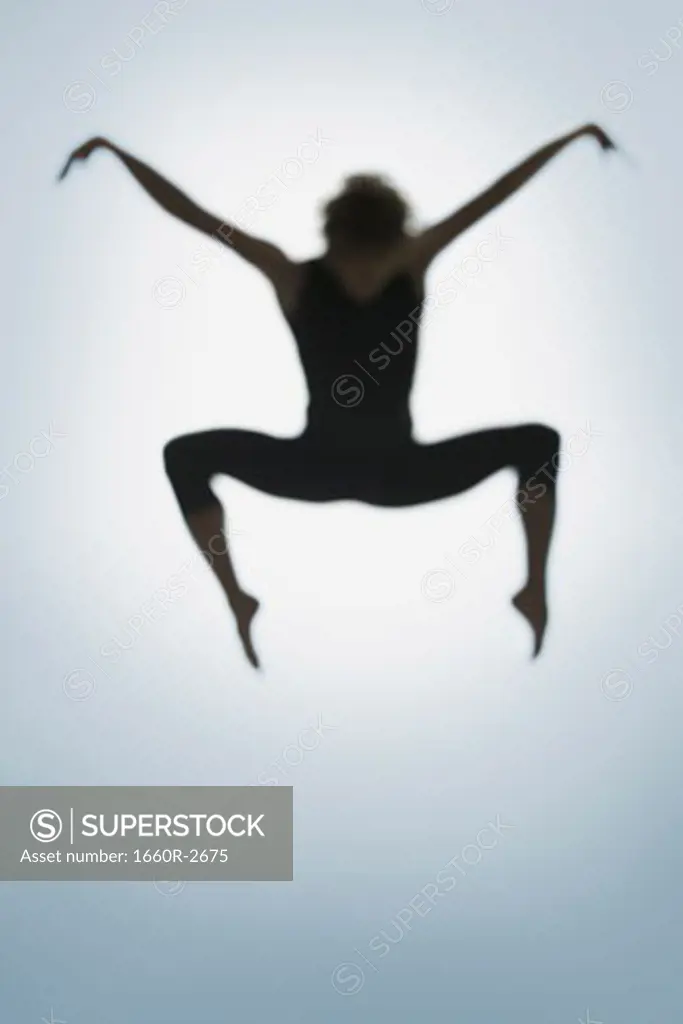 Silhouette of a young man jumping