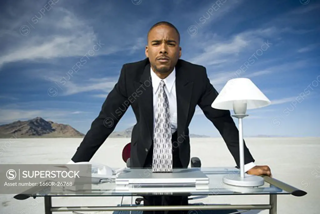 Portrait of a businessman leaning over a table