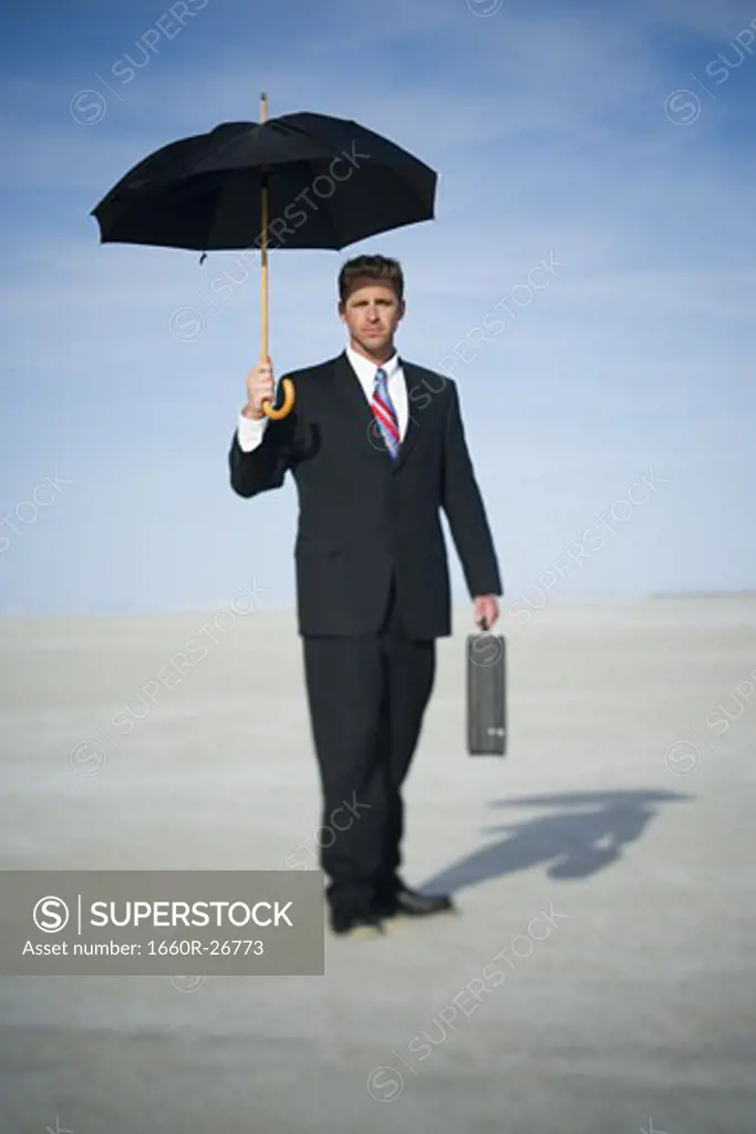 Portrait of a businessman holding an umbrella