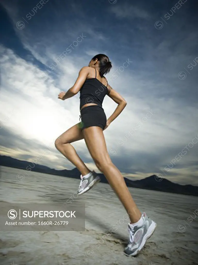 Low angle view of a young woman jogging