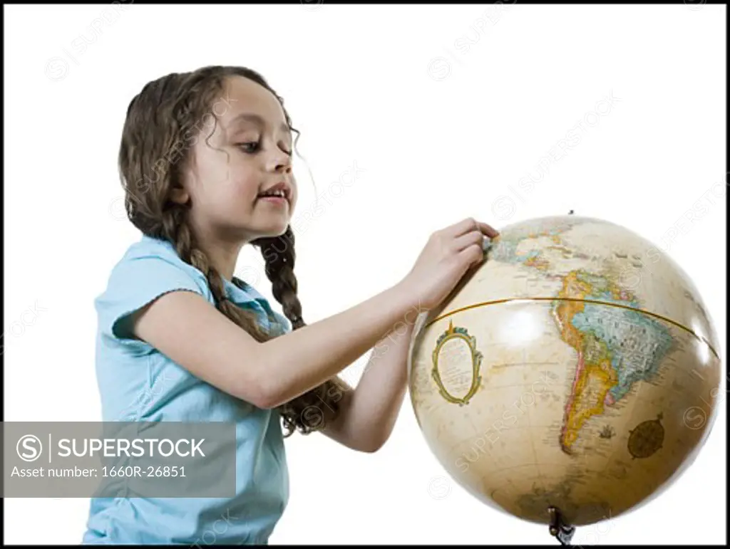 Profile of a girl looking at a globe