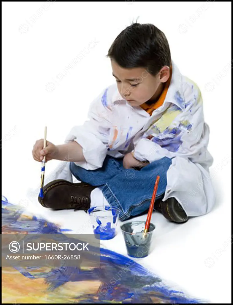 High angle view of a boy painting on the floor