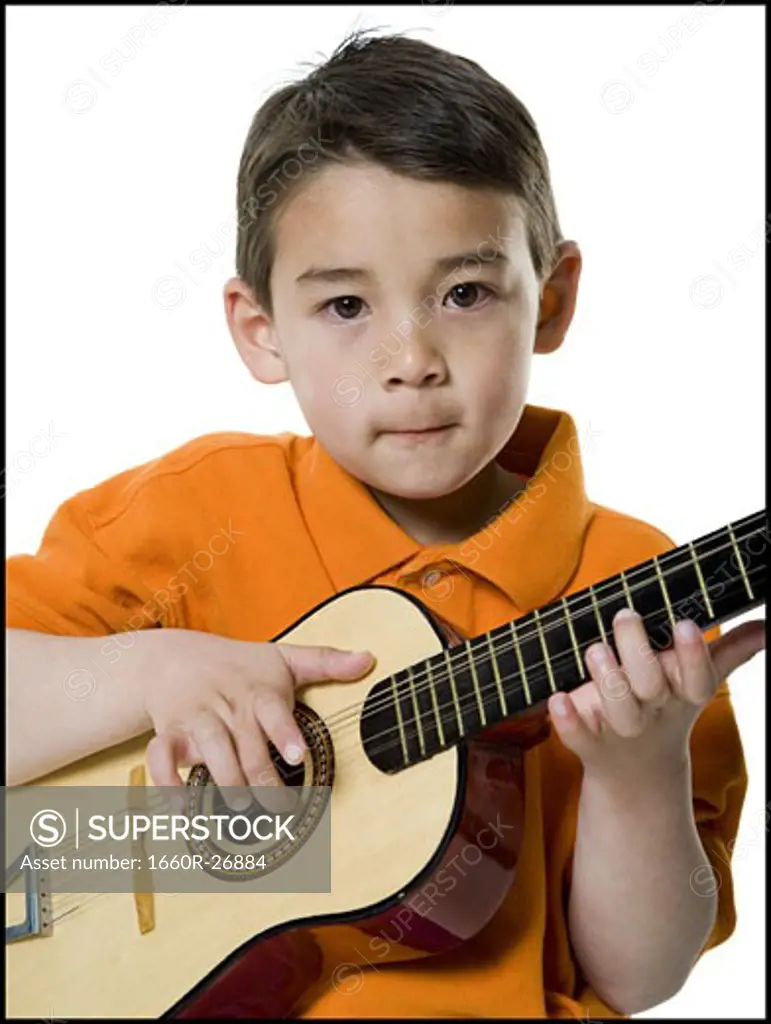 Portrait of a boy playing the guitar