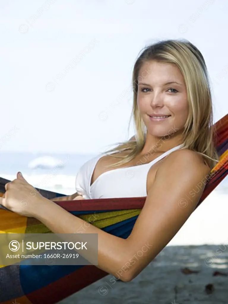 Portrait of a young woman relaxing in a hammock