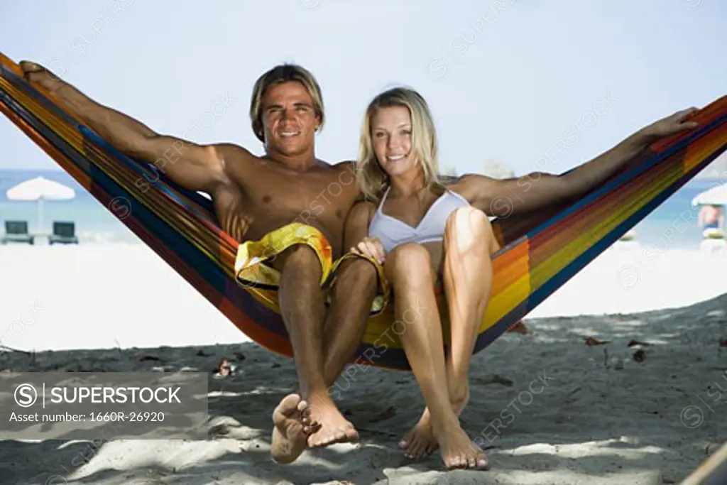 Portrait of a young couple sitting in a hammock