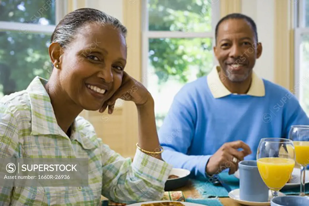 Portrait of a senior man and a senior woman sitting at the breakfast table