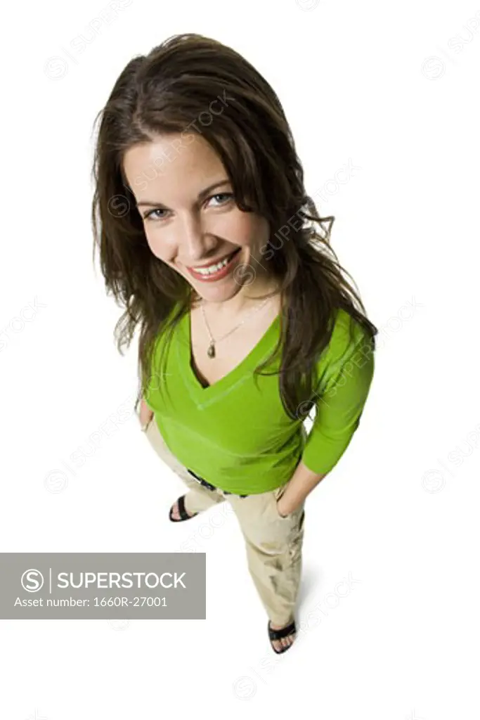 High angle view of a mid adult woman standing with her hands in her pockets