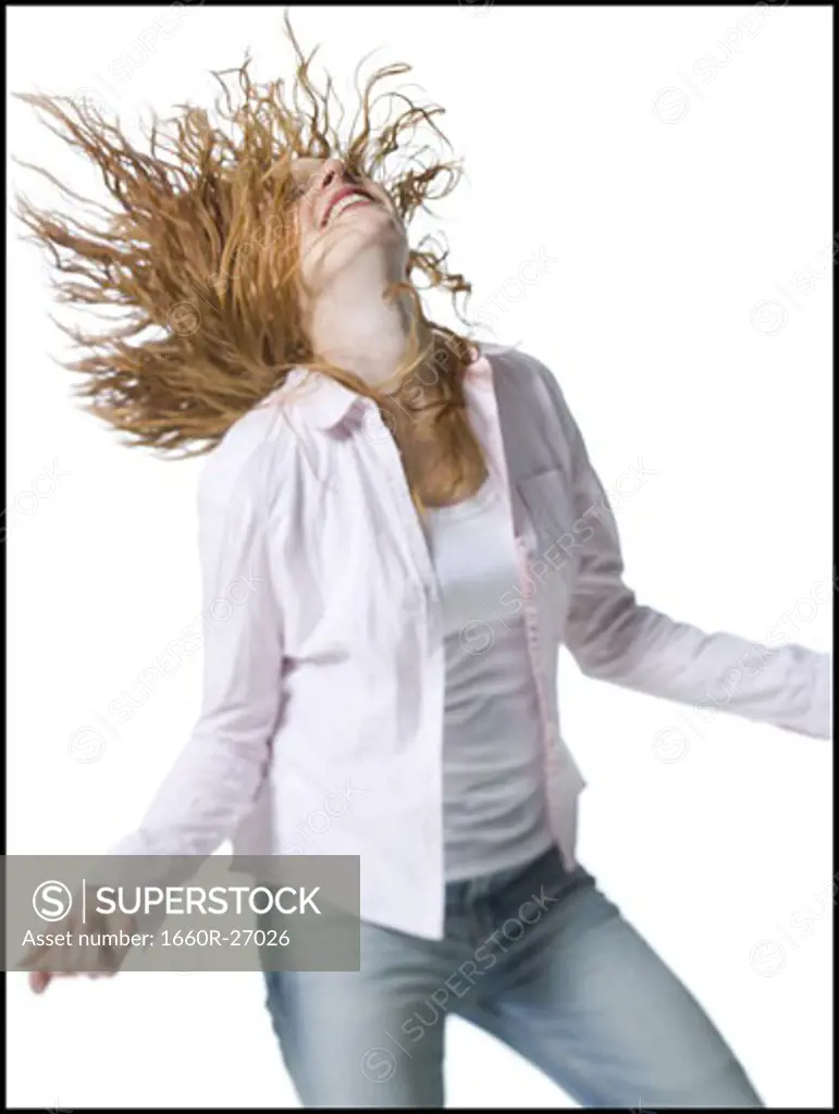 Close-up of a young woman standing with her arms outstretched