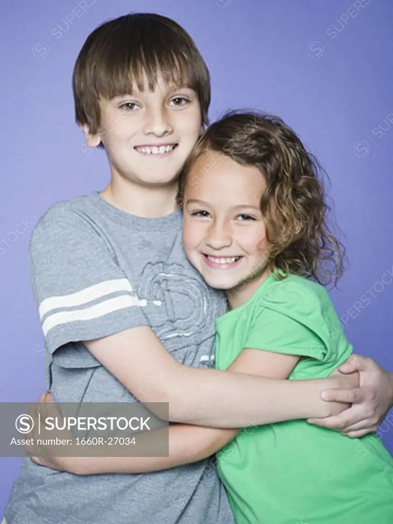 Portrait of a boy embracing his sister