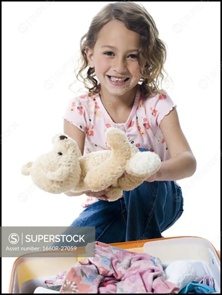 Portrait of a girl holding a teddy bear