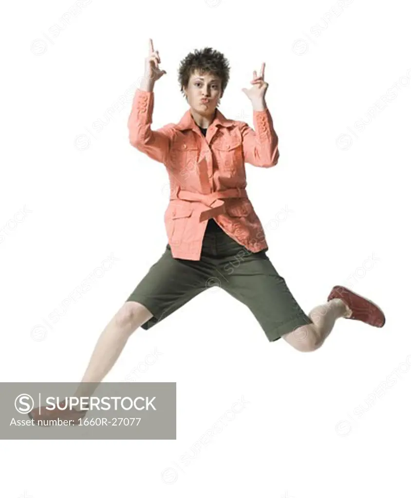 Portrait of a young woman jumping in mid air