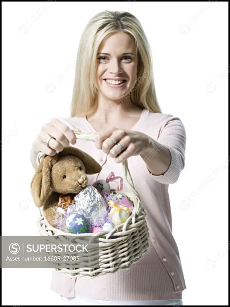 Portrait of a young woman holding a teddy bear in a wicker basket