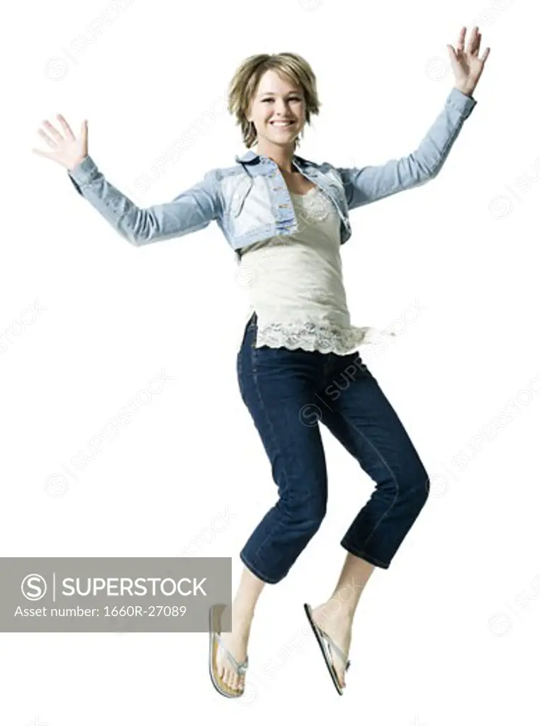 Portrait of a young woman jumping in mid air