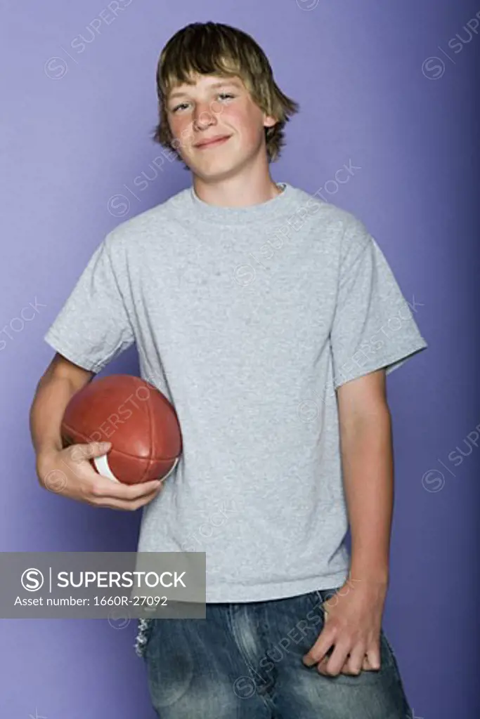 Portrait of a teenage boy holding a rugby ball