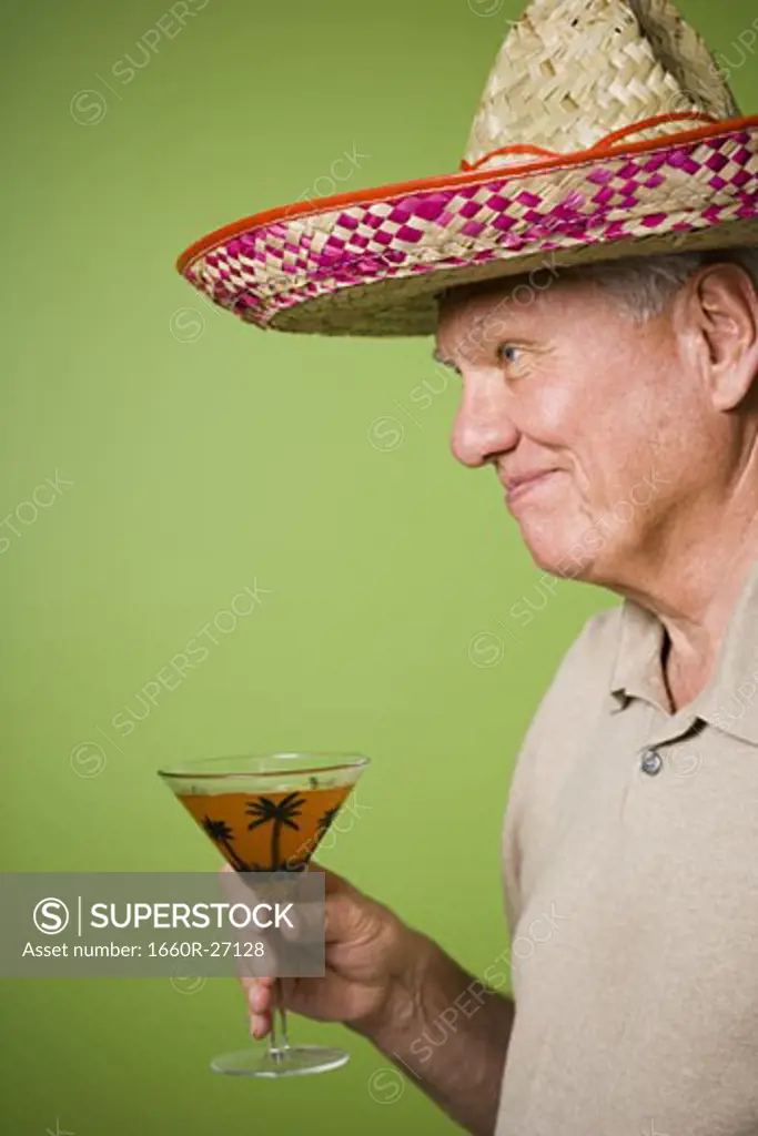 Portrait of an elderly man holding a glass