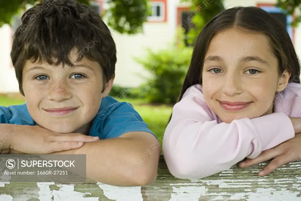 Close-up of a boy and a girl smiling