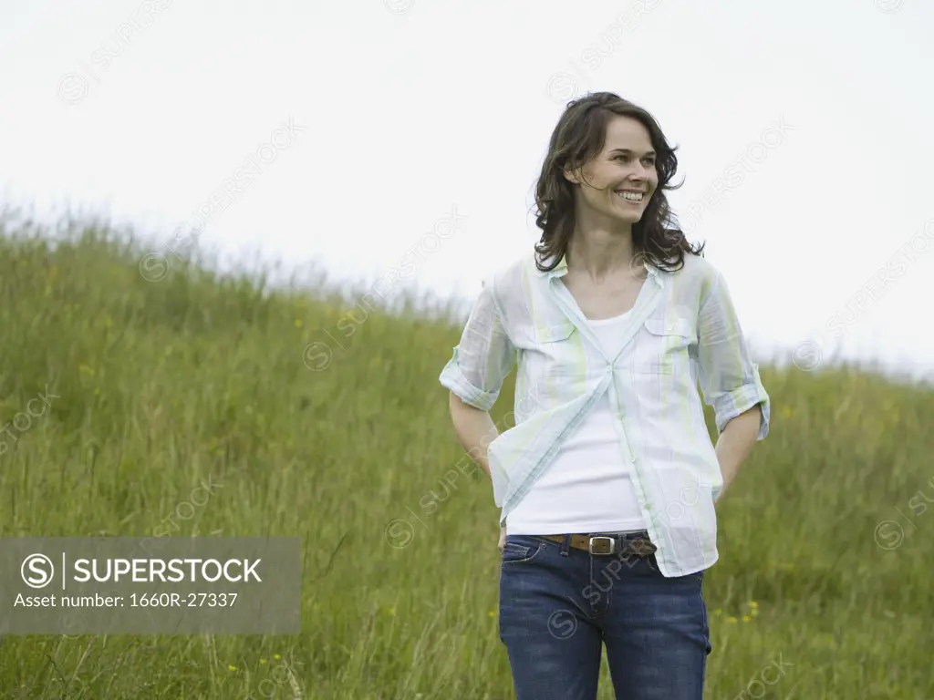 Low angle view of a woman laughing in a field