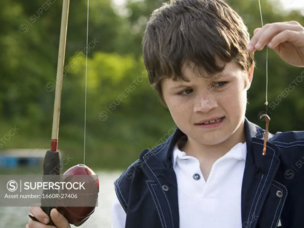 Close-up of a boy holding a fishing rod