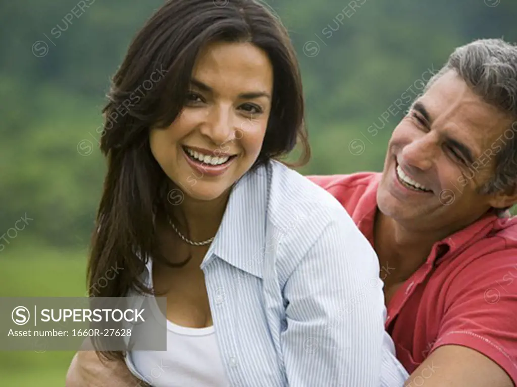 Close-up of a man and a woman smiling