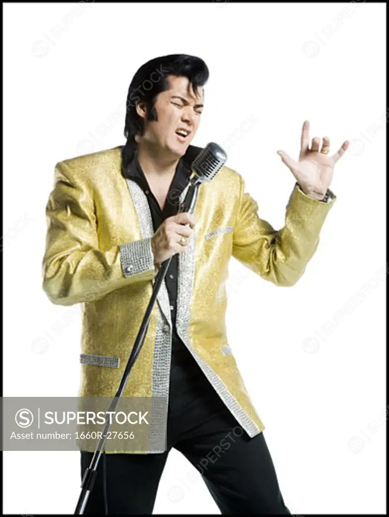 Close-up of an Elvis impersonator singing into a microphone