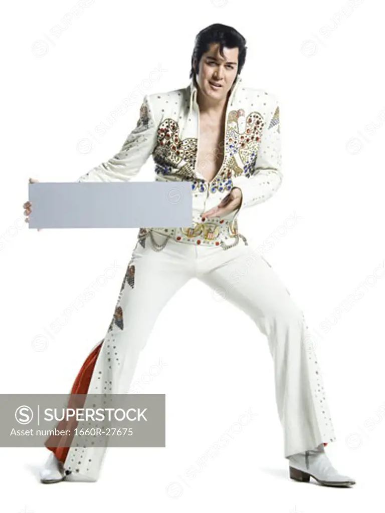 Portrait of an Elvis impersonator holding a blank sign