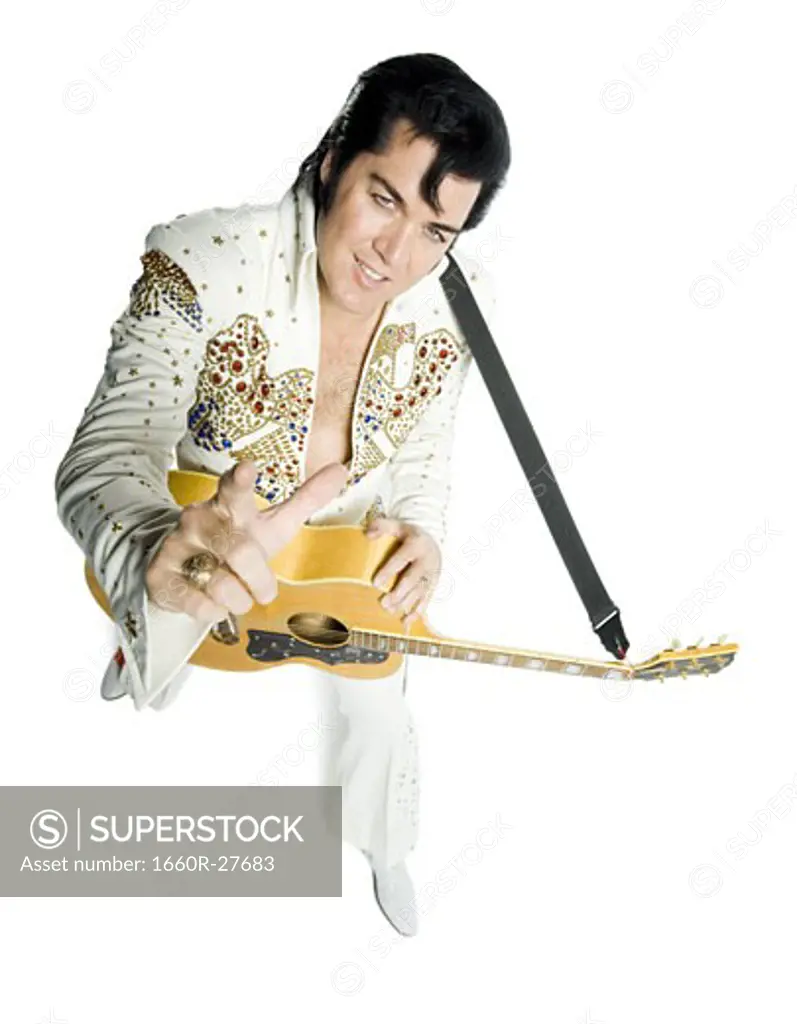 Overhead portrait of an Elvis impersonator holding a guitar