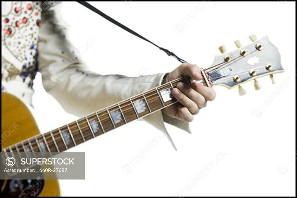 Close-up of an Elvis impersonator playing the guitar