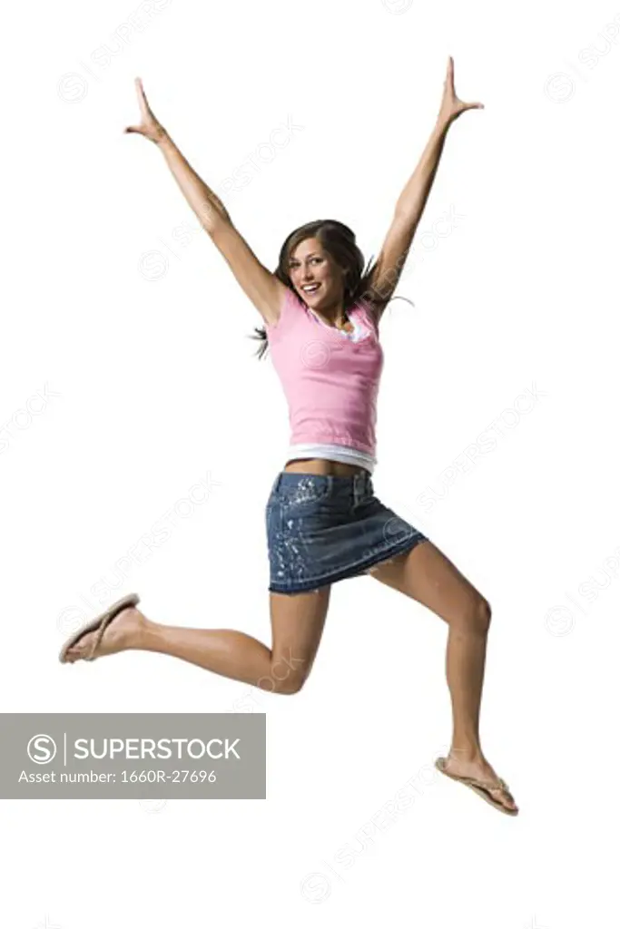 A young woman jumping and smiling