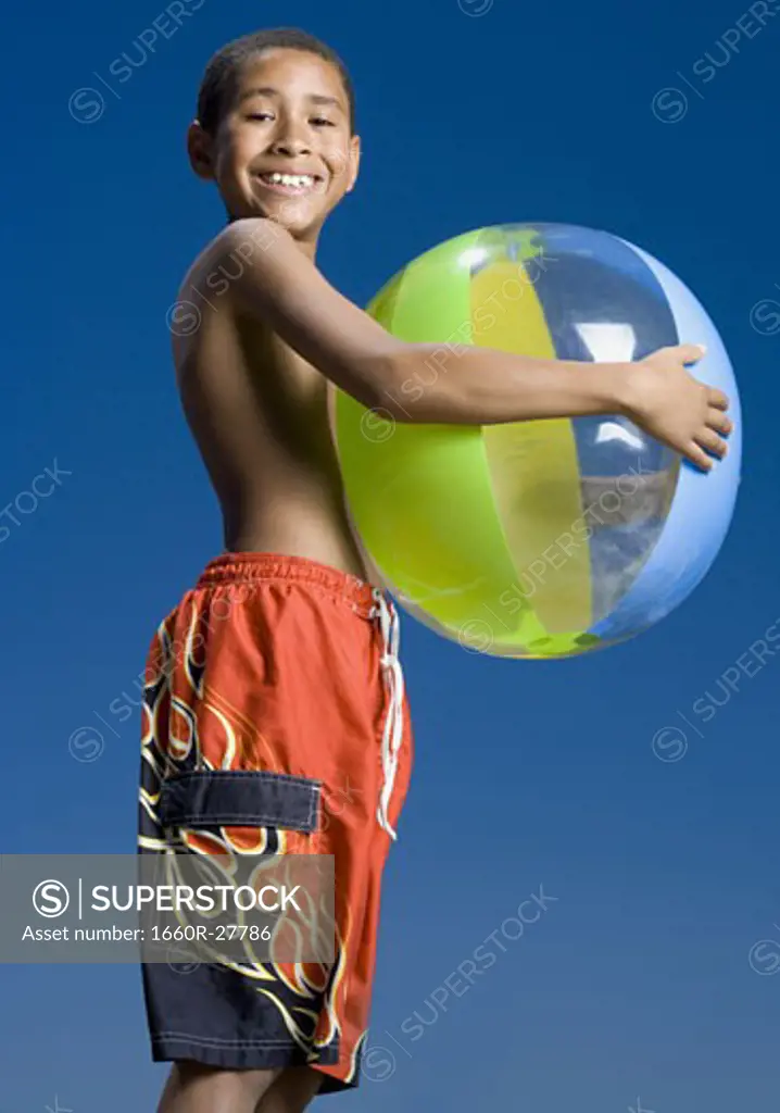 Portrait of a boy holding a beach ball