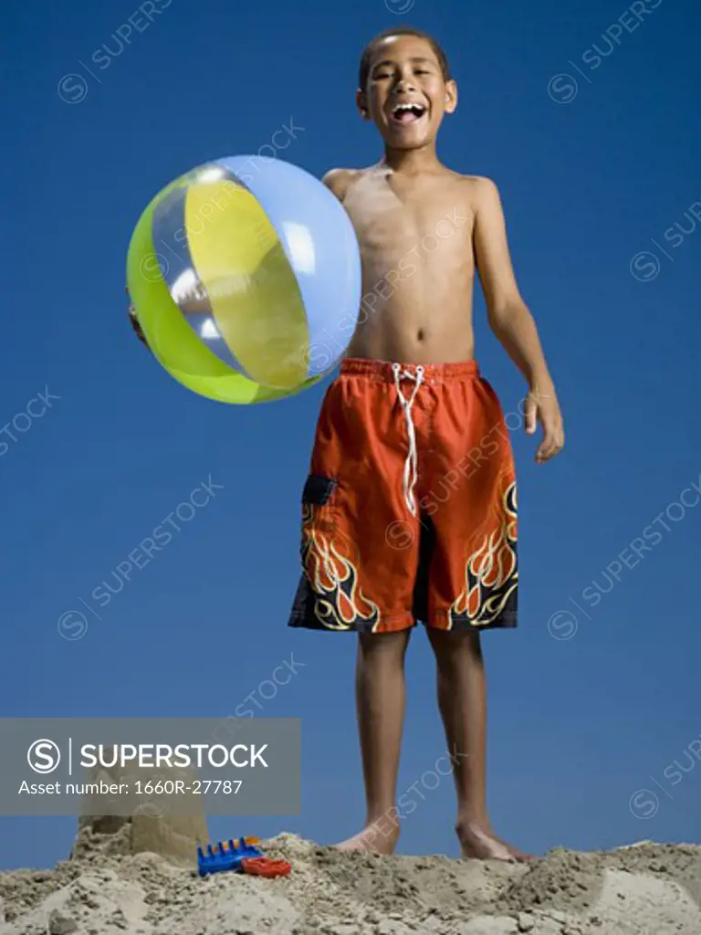 Portrait of a boy holding a beach ball