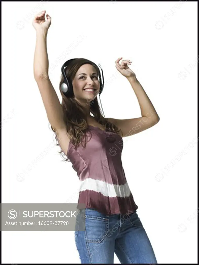 A young woman jumping with her arms raised