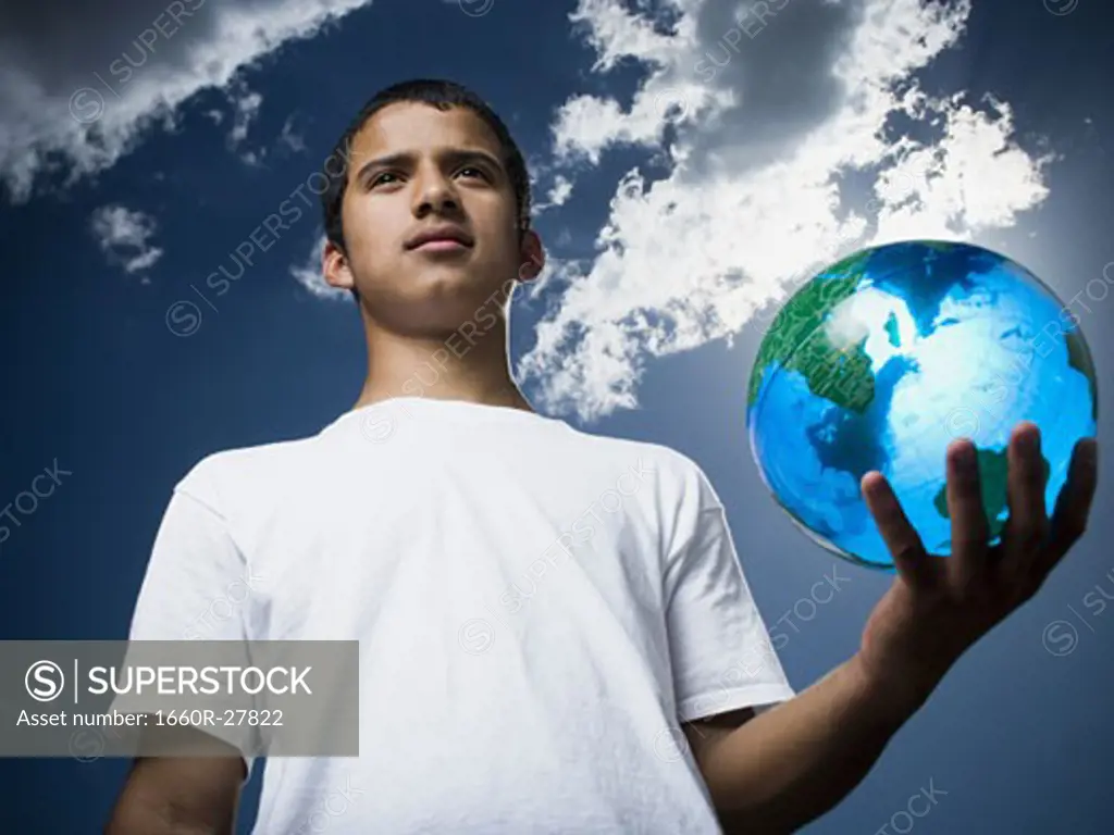 Portrait of a teenage boy holding a globe