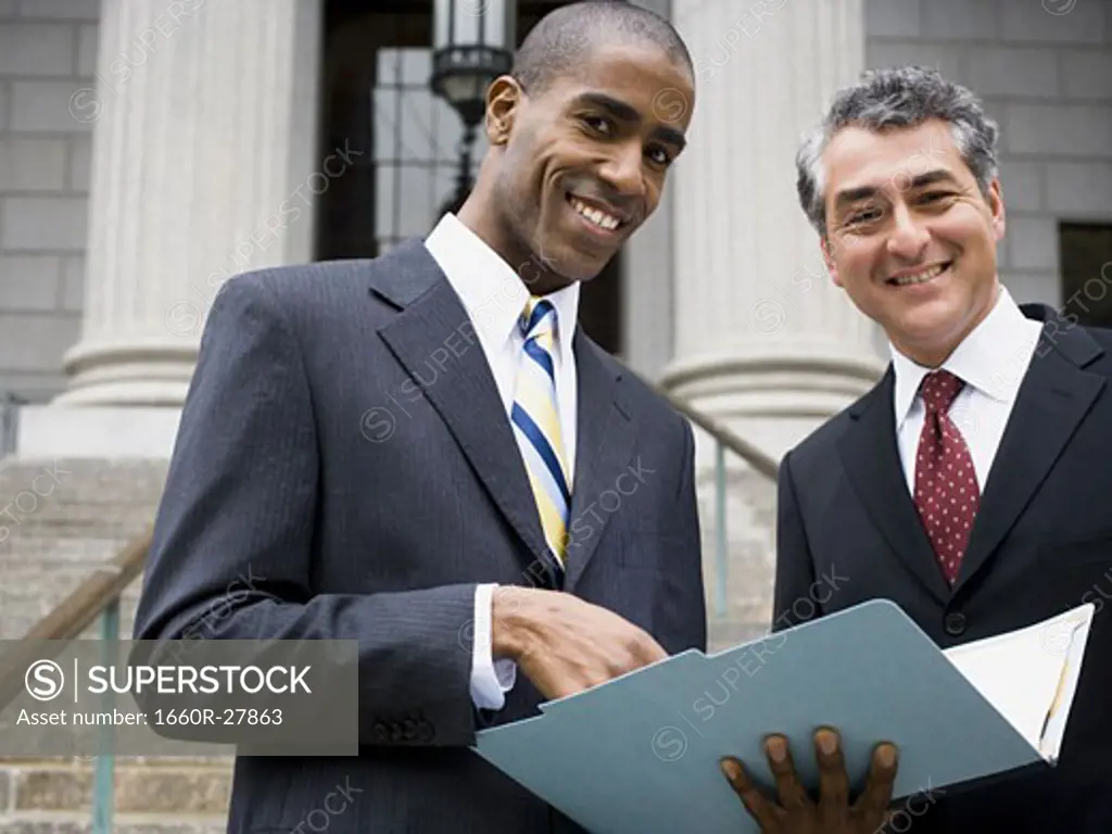 Low angle view of two lawyers smiling