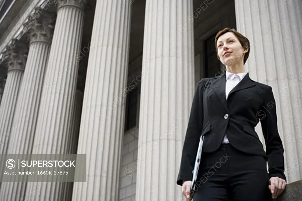 Low angle view of a female lawyer standing in front of a courthouse