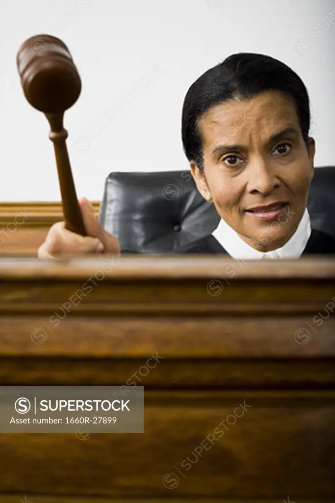Portrait of a female judge holding a gavel and smiling