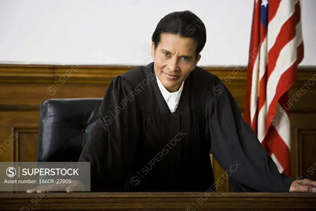 Portrait of a female judge leaning against a bench