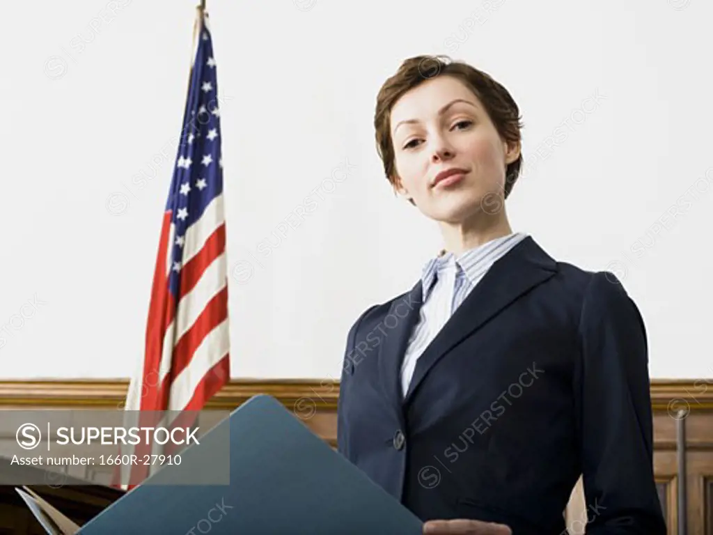 Portrait of a female lawyer standing in a courtroom and smiling