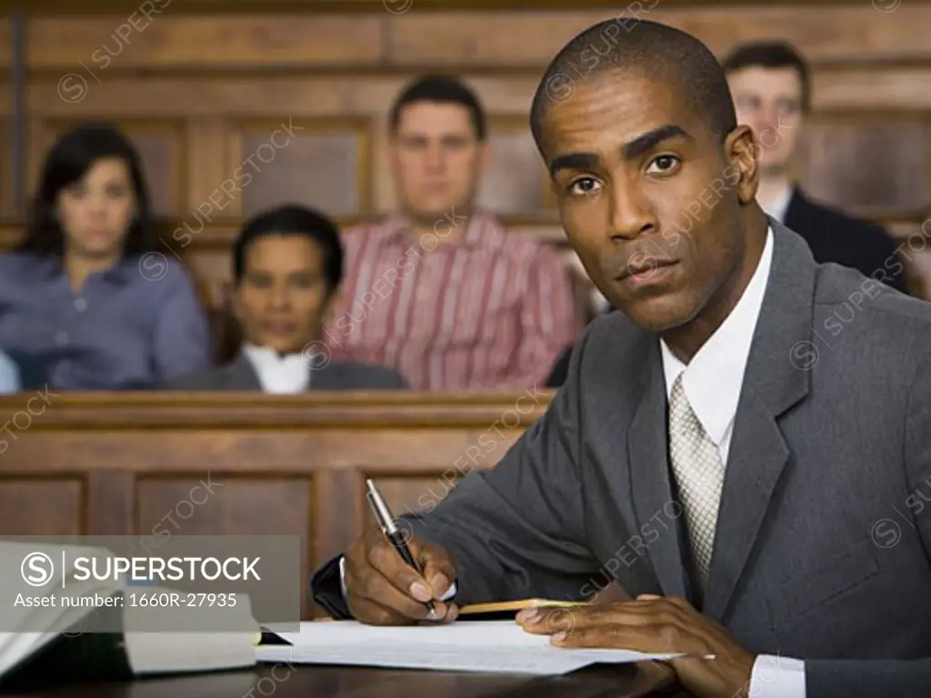 Portrait of a male lawyer sitting in a courtroom